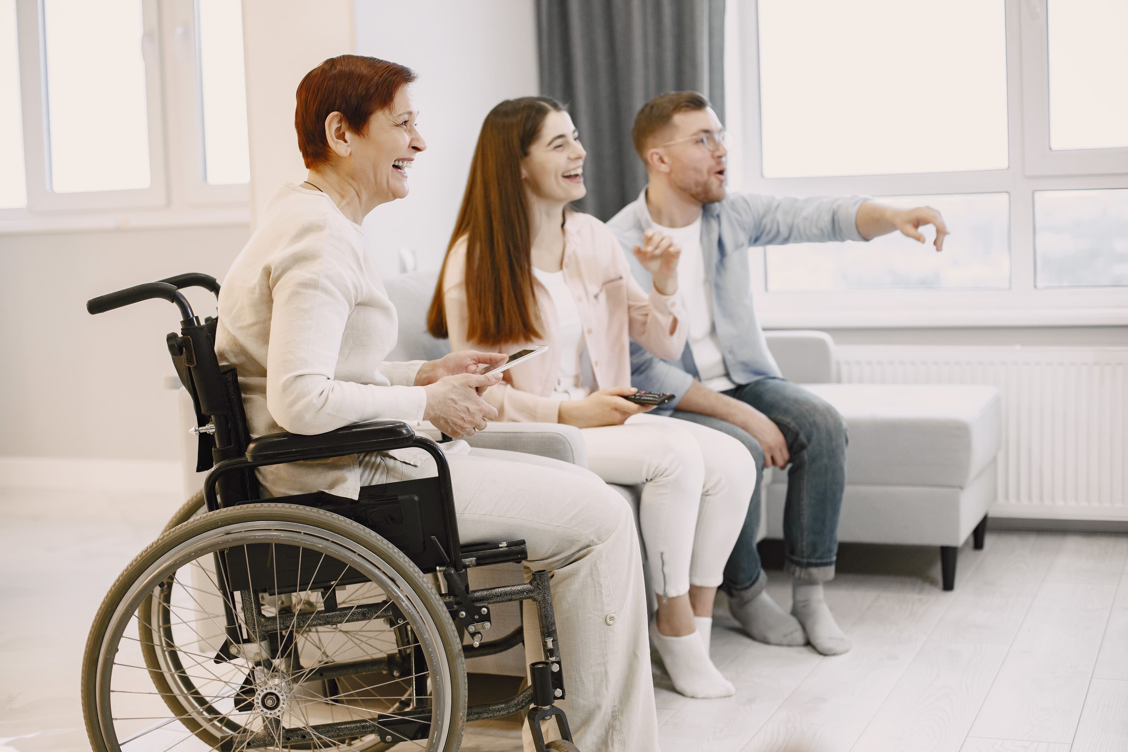 An older woman in a wheelchair spending time with family